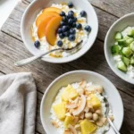 Quick gluten-free breakfast ideas with an assortment of gluten-free breakfast bowls arranged on a table with fresh toppings.
