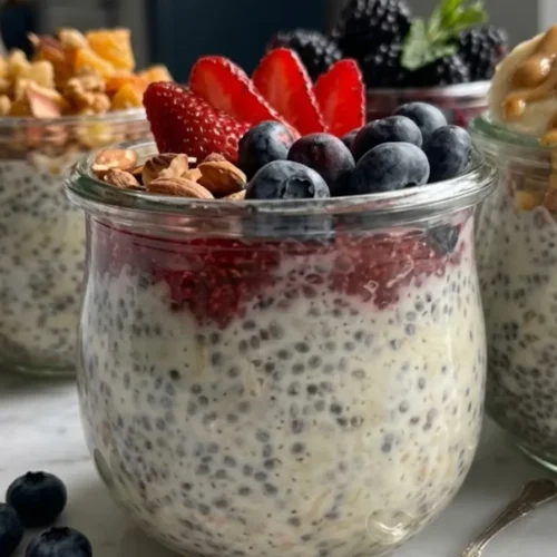 Overnight Oats Recipes: The 3-Minute Breakfast That Saved My Mornings Close-up focus on glass jars filled with creamy chia seed and oat pudding, highlighting easy overnight oats recipes.